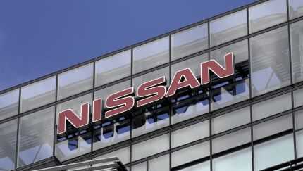 Signage for Nissan Motor is displayed atop the company's headquarters in Yokohama, Japan.