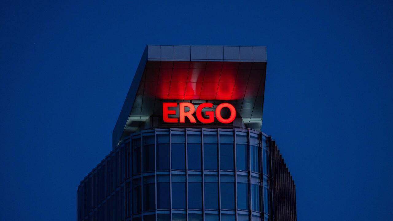 A red illuminated Ergo sign on the side of a building