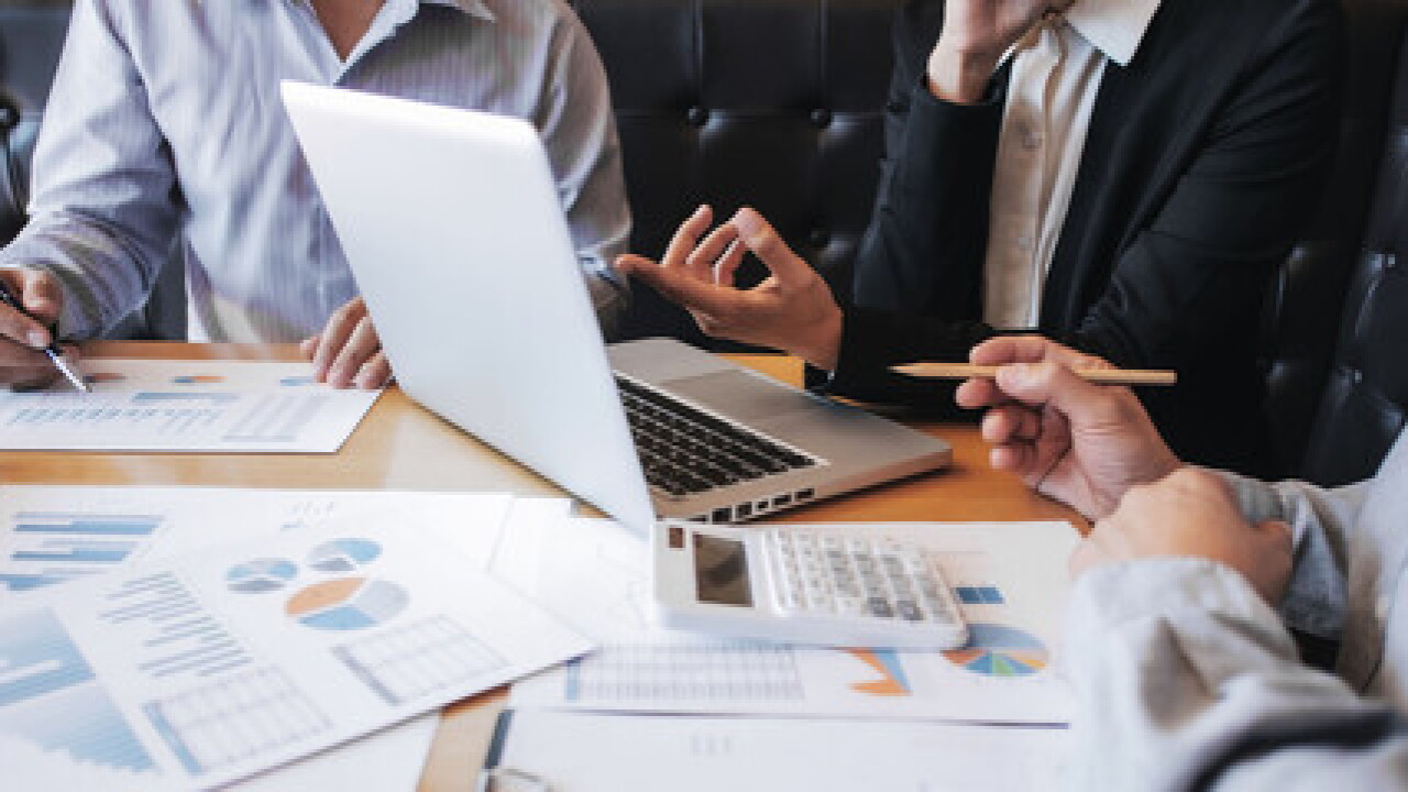 business valuation using laptop, calculator and charts