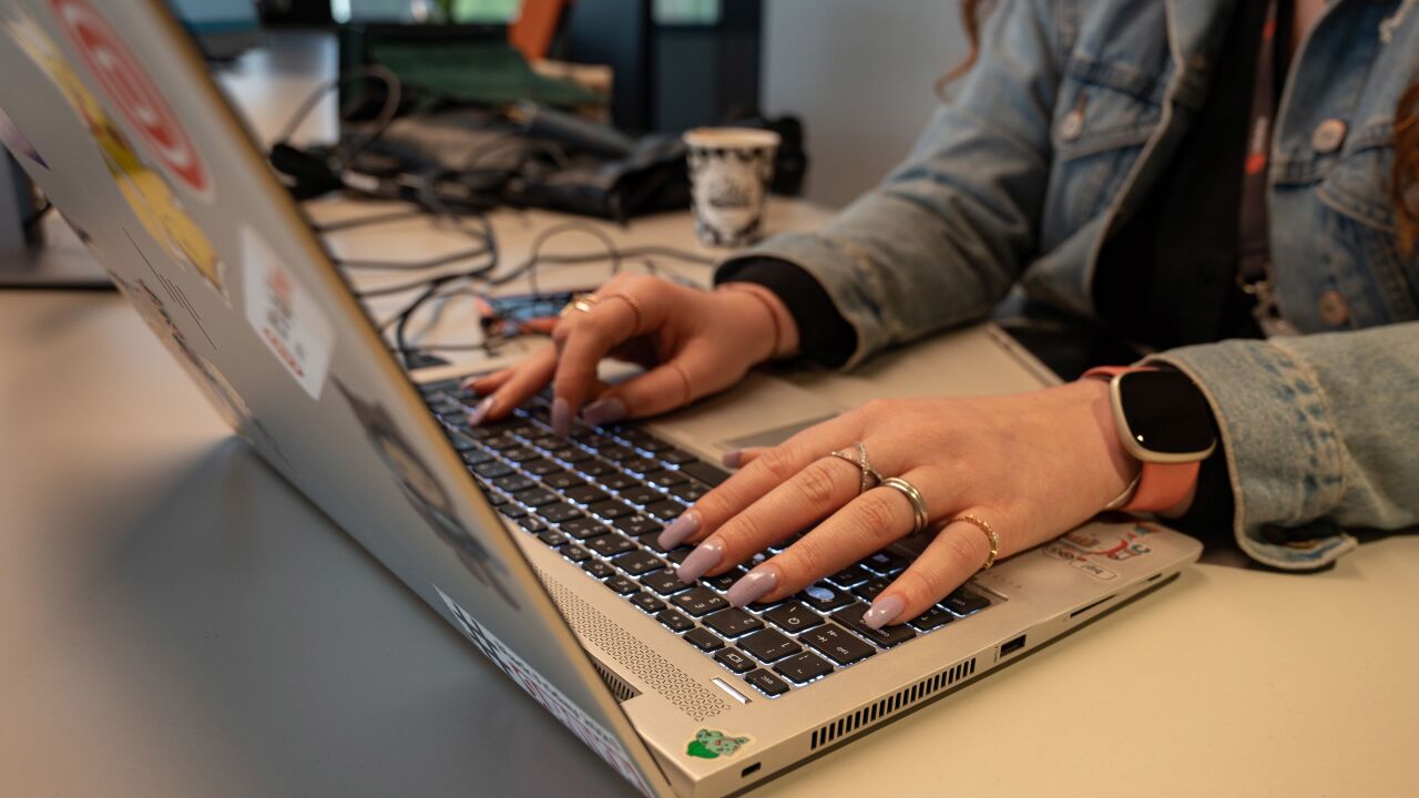An employee works at a laptop computer at the new Infobip Ltd. tech campus in Zagreb, Croatia, on Monday, April 25, 2022. Infobip earlier this year opened the company’s biggest innovation center in Zagreb, with the $21 million, eight-story building enabling a capacity of 800 employees. Photographer: Petar Santini/Bloomberg