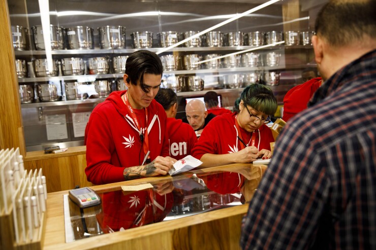 Employees assist customers at the MedMen dispensary in West Hollywood, California, U.S., on Tuesday, Jan. 2, 2018, the day after California launched legal recreational marijuana,