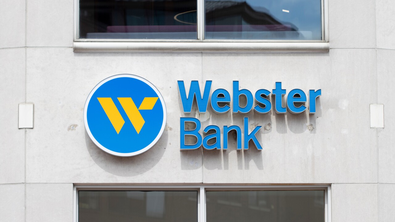 a close-up of a Webster Bank branch, whose logo has a yellow "W" inside a circular blue background.