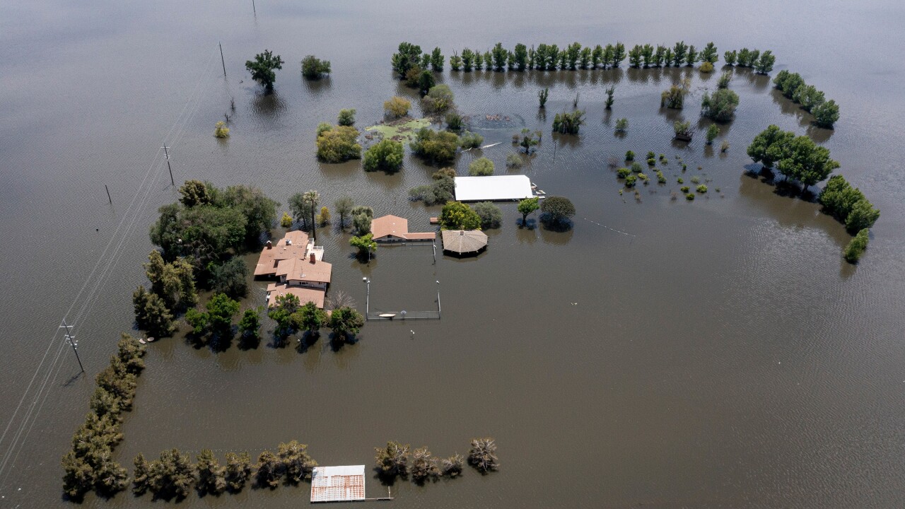 An aerial view of buildings that are flooded.
