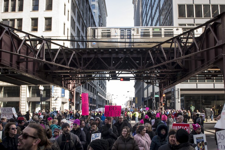 Demonstrators march near the elevated train during the second annual Women's March Chicago in Chicago, Illinois, U.S., on Jan. 20, 2018.