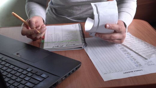 Sad woman with unpaid bills has many debts. Unemployment and per