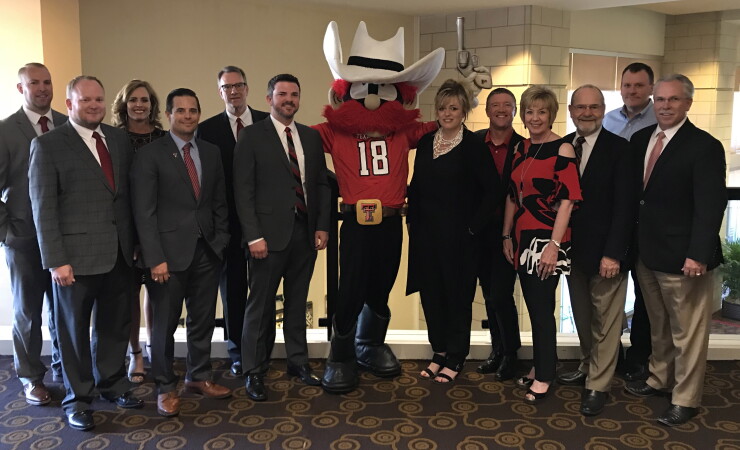 Texas Tech FCU’s board and executive team pose with mascot, Raider Red
