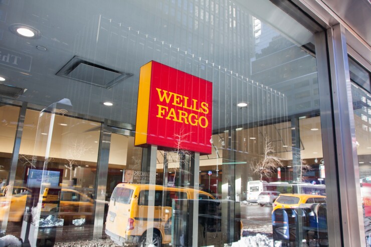 Signage is displayed at a Wells Fargo bank branch in New York.