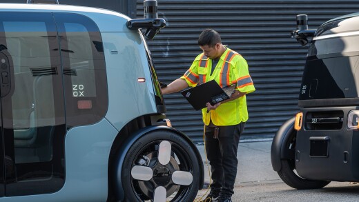 Technician examines back of Zoox robotaxi
