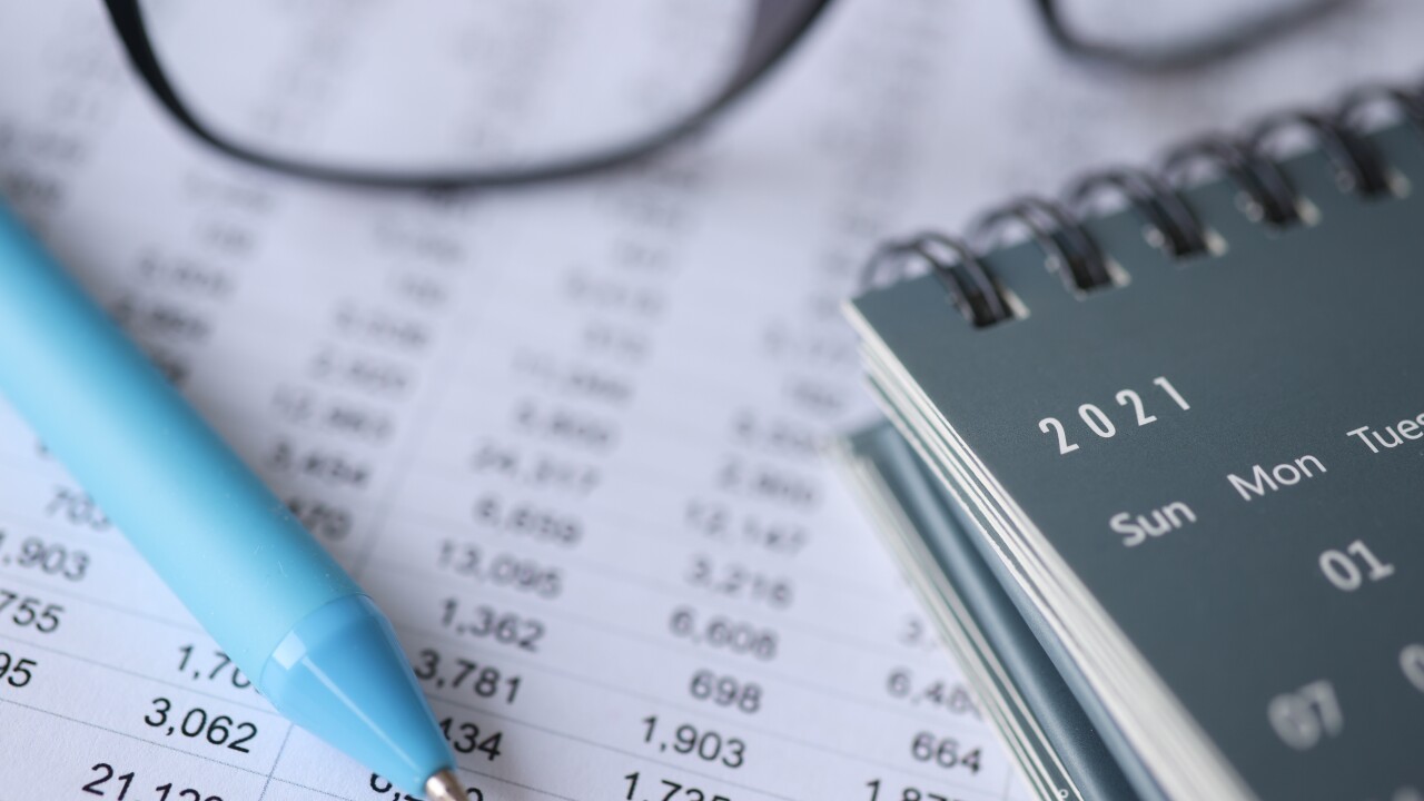 Numbers listed on paper and notepad with 2021 date