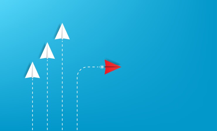 Red paper plane out of line with white papers to change a new way, new idea and innovation concept, courage to stand out and unique