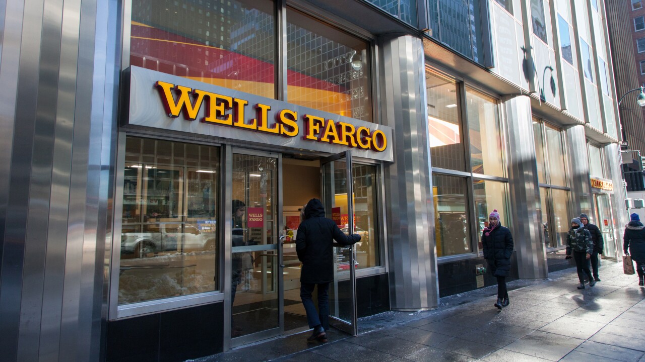 A customer enters a Wells Fargo bank branch in New York.