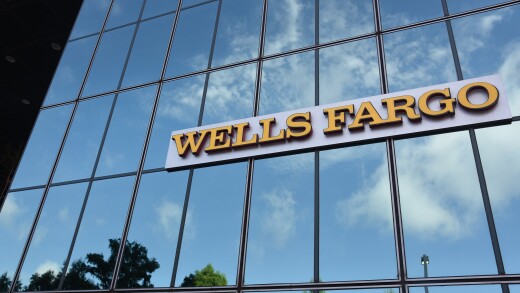 Wells Fargo signage is displayed on the exterior of a bank branch in Dallas.