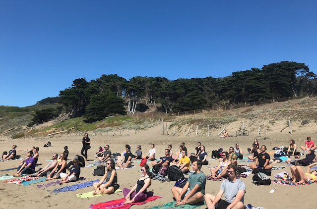 SmartBiz Loans employees do yoga on the beach