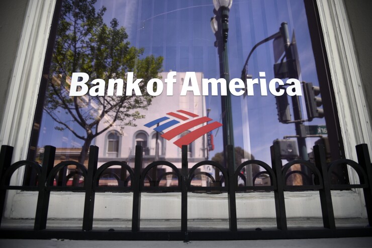 Buildings are reflected in the window of a Bank of America Corp. branch in Alameda, California, U.S., on Monday, April 9, 2018.