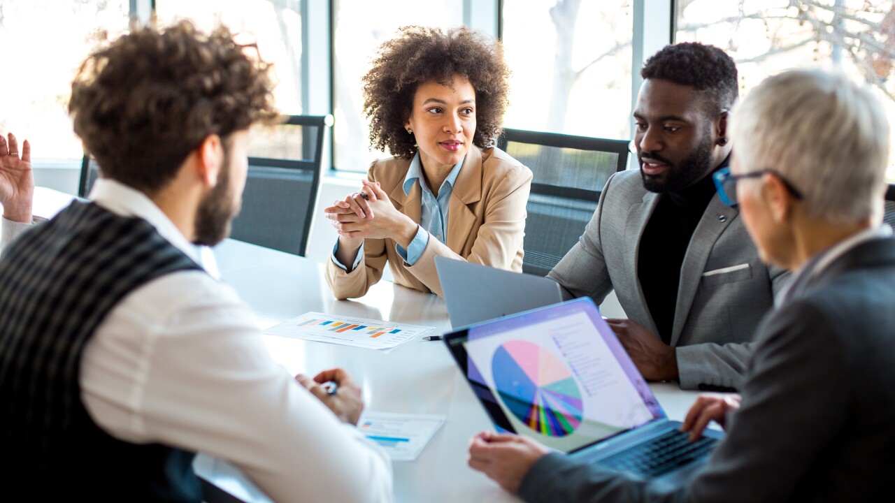 Employees in conference room talking