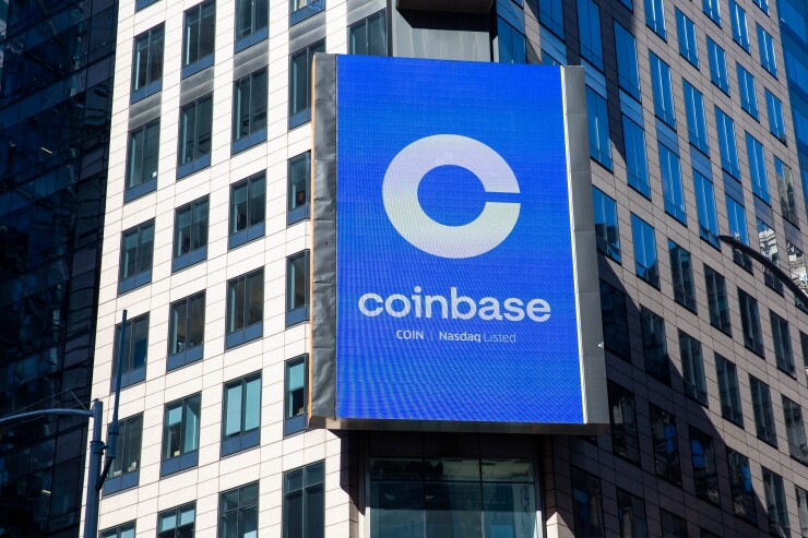 A monitor displays Coinbase signage during the company's IPO at the Nasdaq MarketSite in New York.