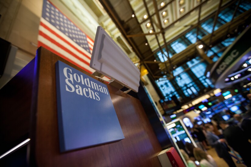 Goldman Sachs signage is displayed at the company's booth on the floor of the New York Stock Exchange.