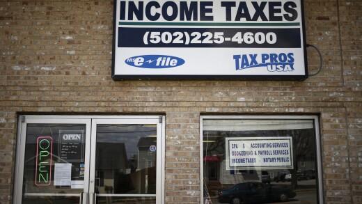 Signage advertising income tax service is pictured in front of Tax Pros USA in La Grange, Kentucky, U.S., on Wednesday, April 9, 2014. The deadline for filing federal income tax returns to the Internal Revenue Service is Tuesday, April 15. Photographer: Luke Sharrett/Bloomberg