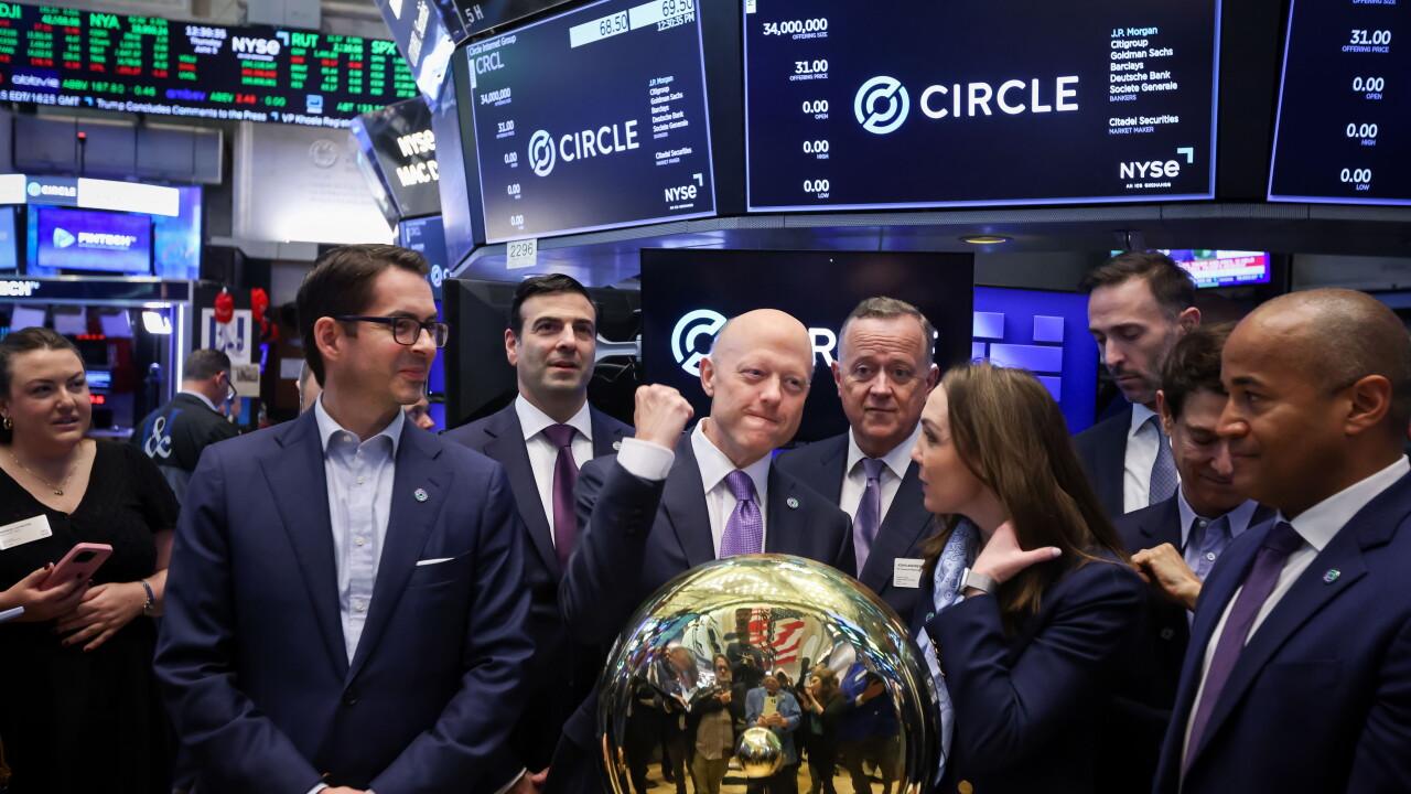 Executives in suits gather around a gold podium on the NYSE floor beneath screens showing the Circle stock logo.