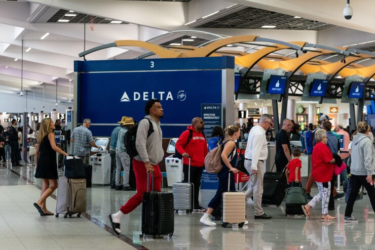 Travelers at Hartsfield-Jackson Atlanta International Airport on May 25, 2023.