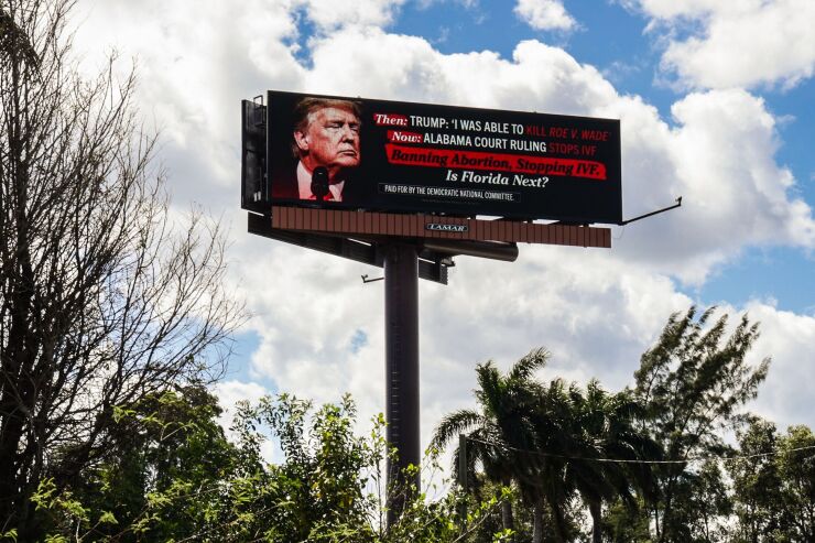 A billboard sign explaining how Trump killed Roe v. Wade.