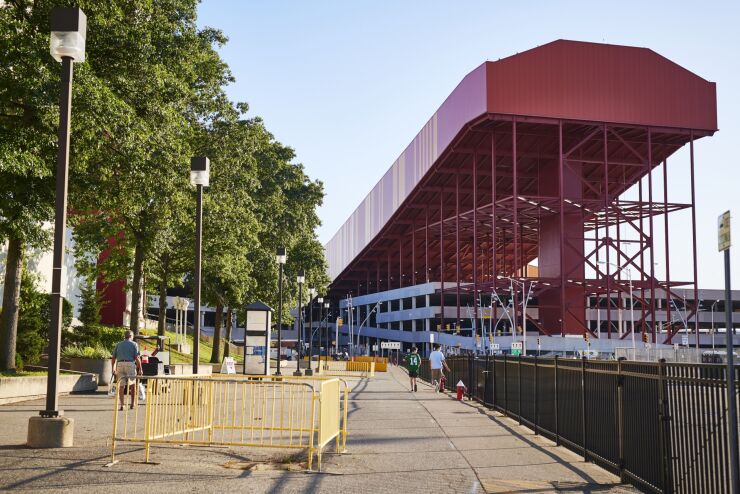 Pedestrians pass in front of the ramp for the American Dream complex indoor ski slope in East Rutherford, New Jersey, U.S., on Thursday, Aug. 29, 2019.