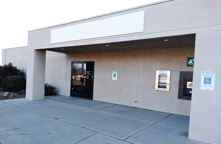 The building that once housed National Bank of Arizona is Vacant, expect for an ATM operated by another company, which charges $2.75 for a cash withdrawal.