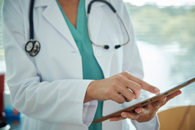 Doctor scrolling on an iPad