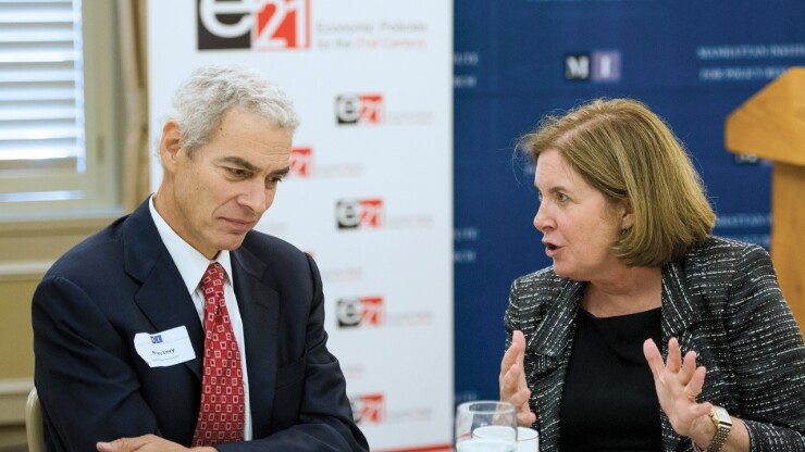 Mickey Levy and Esther George, seated, have a discussion.