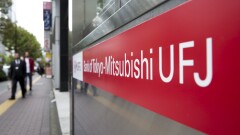 Pedestrians walk past a Bank of Tokyo-Mitsubishi branch in Tokyo.