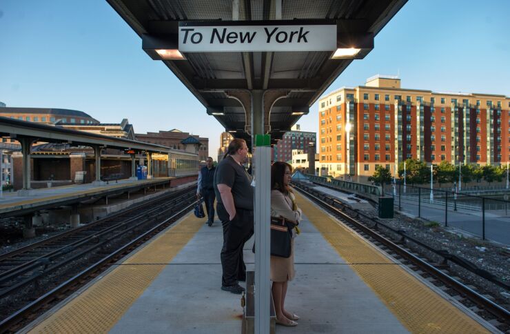 Commuters wait to board a Metro-North Railroad train at the Yonkers Terminal in Yonkers, New York, U.S., on Thursday, Sept. 19, 2013.