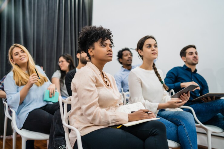 Group of diverse employees sitting in a meeting