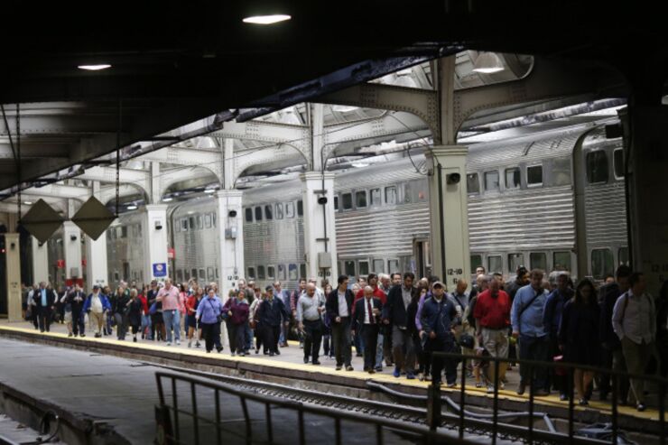 Passengers from a Chicago-area Metra commuter train walk down the platform inside Union Station in Chicago, Illinois, U.S., on Thursday, Oct. 8, 2015.