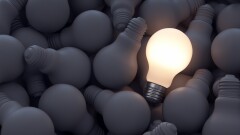 Bright lighbulb on pile of gray bulbs innovation idea concept