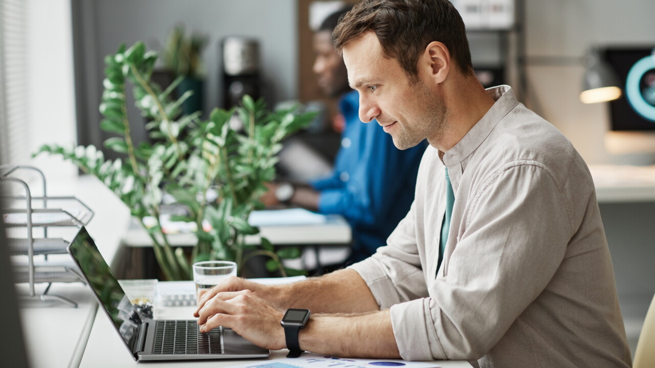 Man working at desk on laptop