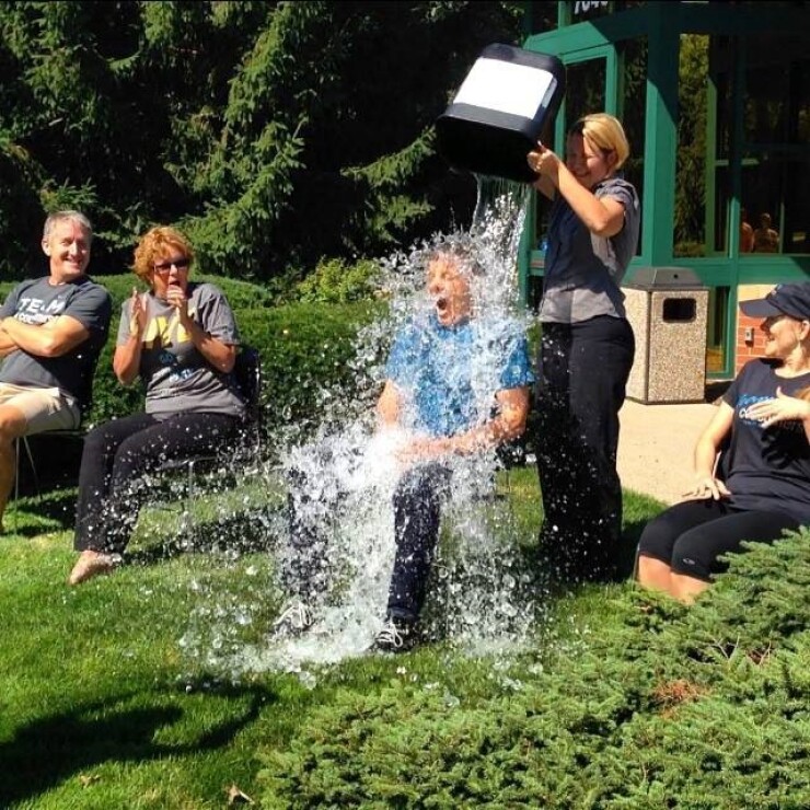 CEO Kit Snyder participates in the Ice Bucket Challenge with help from assistant Heather Koprolces, while (left to right) CFO Steve Howard, CMO Lynne Jarman-Johnson and CHRO Shawn Premer look on.