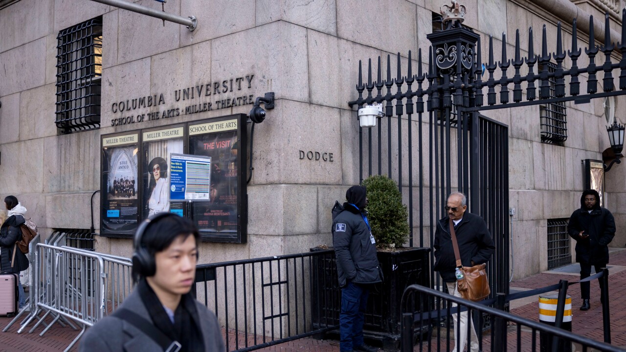 People walk near an entrance to the Columbia University campus
