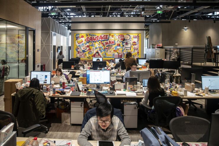 Employees work in XD Inc.'s office in Shanghai, China, on Thursday, Jan. 21, 2021. Shares in indie game distributor XD rose 24% on the first trading day of 2021 after Huawei Technologies Co. temporarily removed all Tencent Holdings Ltd. games from its app store in a dispute over their revenue split. Photographer: Qilai Shen/Bloomberg