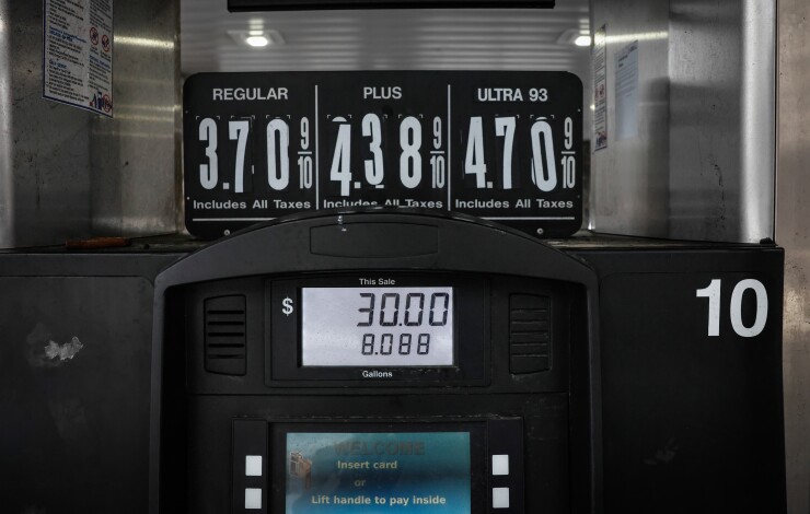 A picture of a gas station pump, with the prices displayed above it.