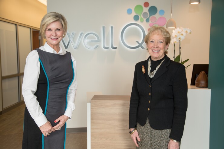 Cathy J. Pace, left, president and CEO of Allegacy Federal Credit Union and Julie Ann Freischlag, M.D., CEO of Wake Forest Baptist Medical Center and interim dean of Wake Forest School of Medicine, stand in the WellQ lobby.