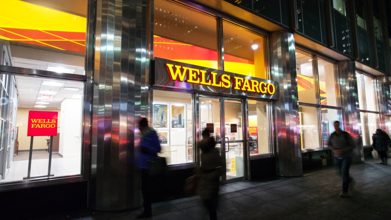 Pedestrians pass in front of a Wells Fargo & Co. bank branch in New York, U.S., on Tuesday, Jan. 9, 2018. Wells Fargo & Co. is scheduled to release earnings figures on January 12. Photographer: Daniel Tepper/Bloomberg