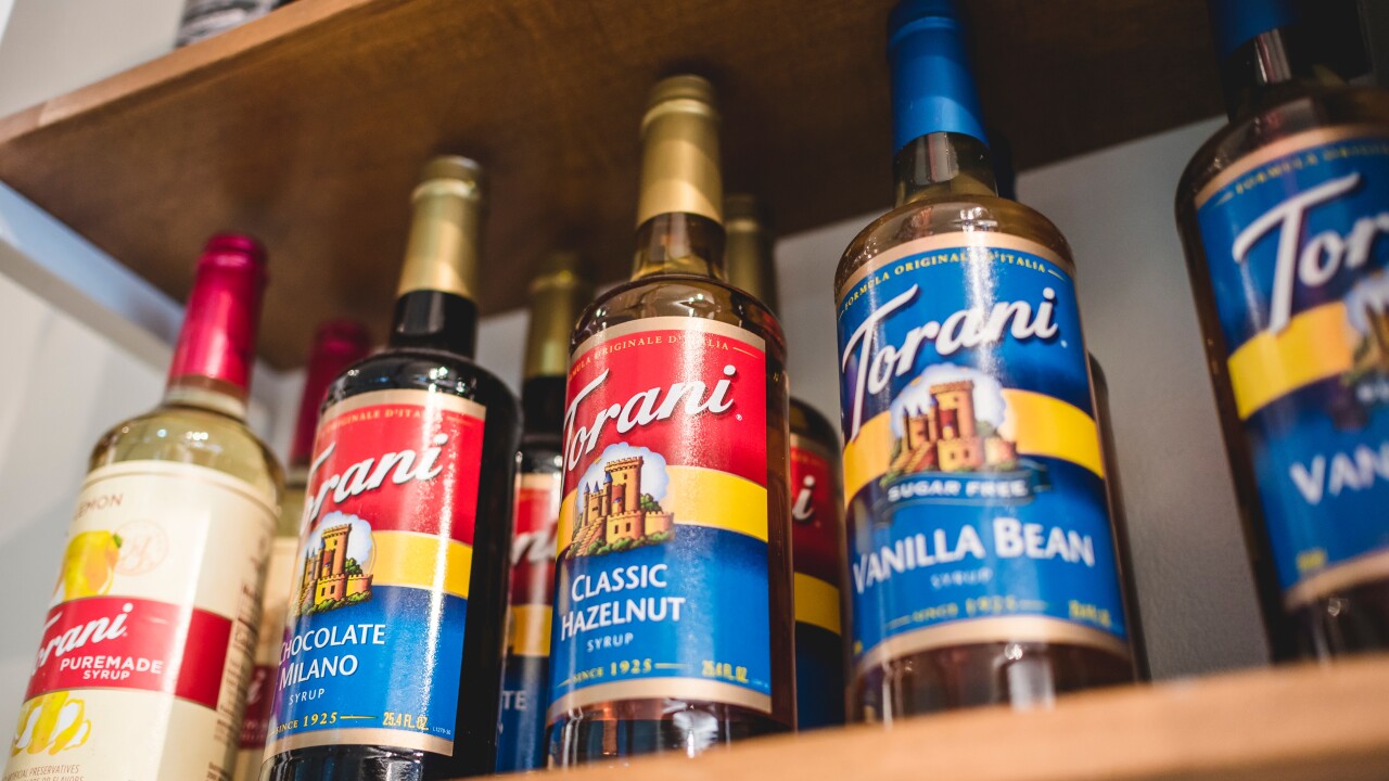 Torani syrups on the shelf of a coffeehouse.