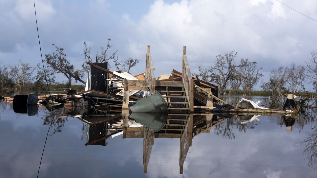 The remains of a house destroyed by a hurricane submerged in floodwater. Photographer: Mark Felix/Bloomberg