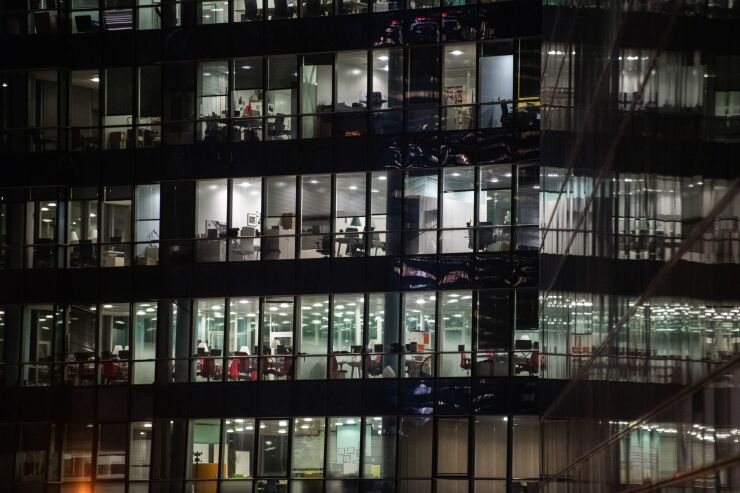 Illuminated office space in a commercial property at dawn in the La Defense business district in Paris, France, on Thursday, Jan. 21, 2021. The shift of jobs and assets to Paris after Brexit will accelerate this year, providing Europe with an opportunity to strengthen its own financial infrastructure, according to Bank of France Governor Francois Villeroy de Galhau. Photographer: Benjamin Girette/Bloomberg