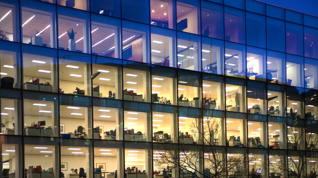 The illuminated windows of an office building