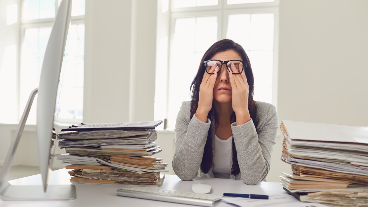 Woman looking stressed and overwhelmed at work
