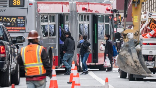Passengers board a transit bus in San Francisco