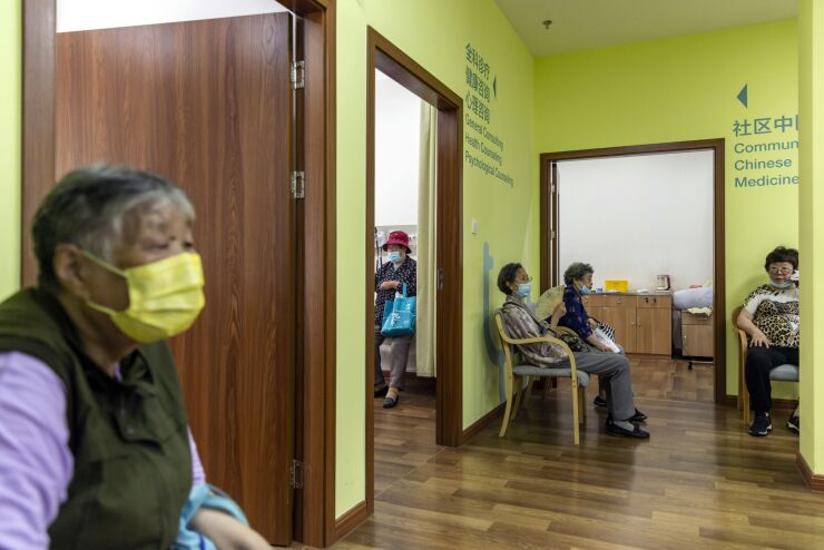 Elderly people wait outside health consultation rooms at an community elderly care center in Shanghai, China, on Thursday, June 3, 2021. The Shanghai Changning Elderly Service Time Bank, part of a government pilot program designed to address the needs of China’s growing ranks of senior citizens, relies on members to provide a slew of services, and those members in turn can use their donated hours to access the same resources. Photographer: Qilai Shen/Bloomberg