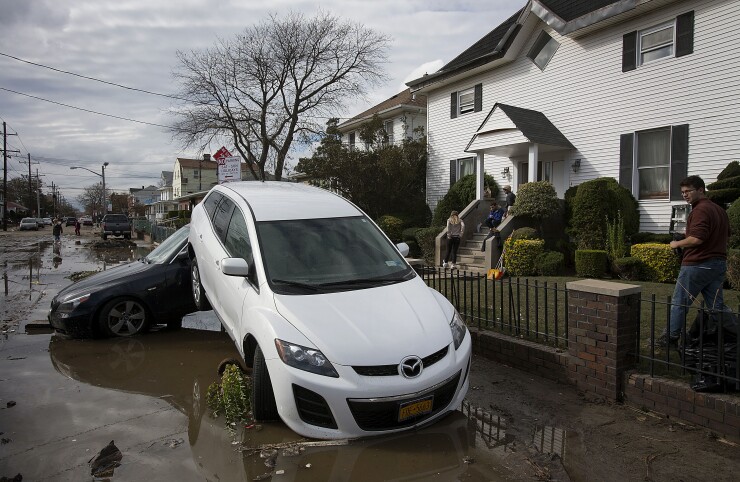 Cars sit piled up on the side of the road in the Rockaway area of New York.