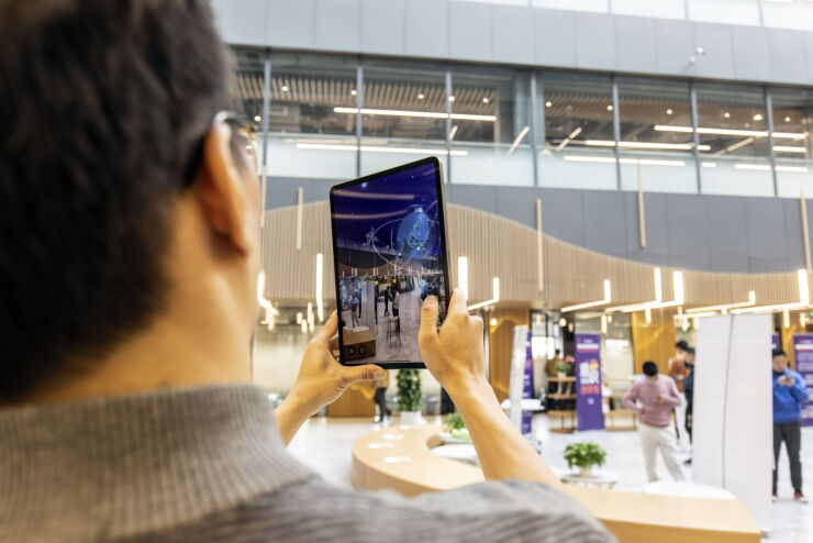 An employee uses a tablet to demonstrate an augmented reality (AR) application in an atrium at the SenseTime Group Inc. headquarters in Shanghai, China, on Friday, Dec. 3, 2021. Chinese artificial intelligence giant SenseTime rose on its first day of trading in Hong Kong after a rocky initial public offering that was delayed by concerns over fresh U.S. sanctions. Photographer: Qilai Shen/Bloomberg